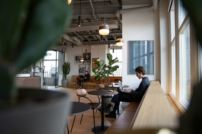 gig economy worker sitting at a couch working